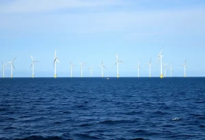 Construction of the Revolution Wind project offshore with turbines in the background.
