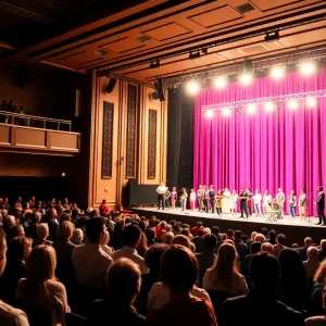 Stage setting for URI Theater Season with audience in background.
