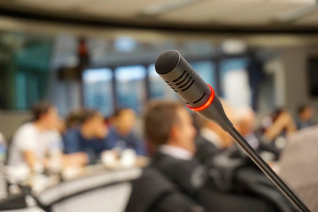 Microphone in front of a seated audience