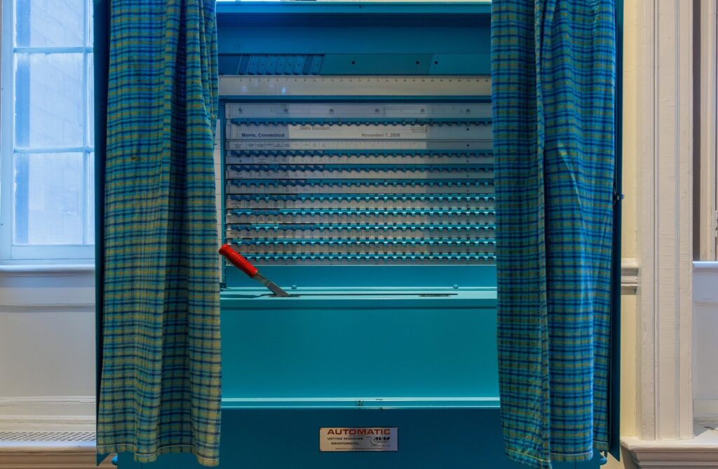 Voting booth with curtains open at a polling place